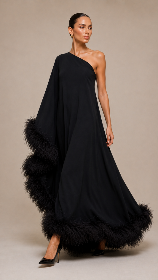 Woman wearing a black one-shoulder gown with feather details