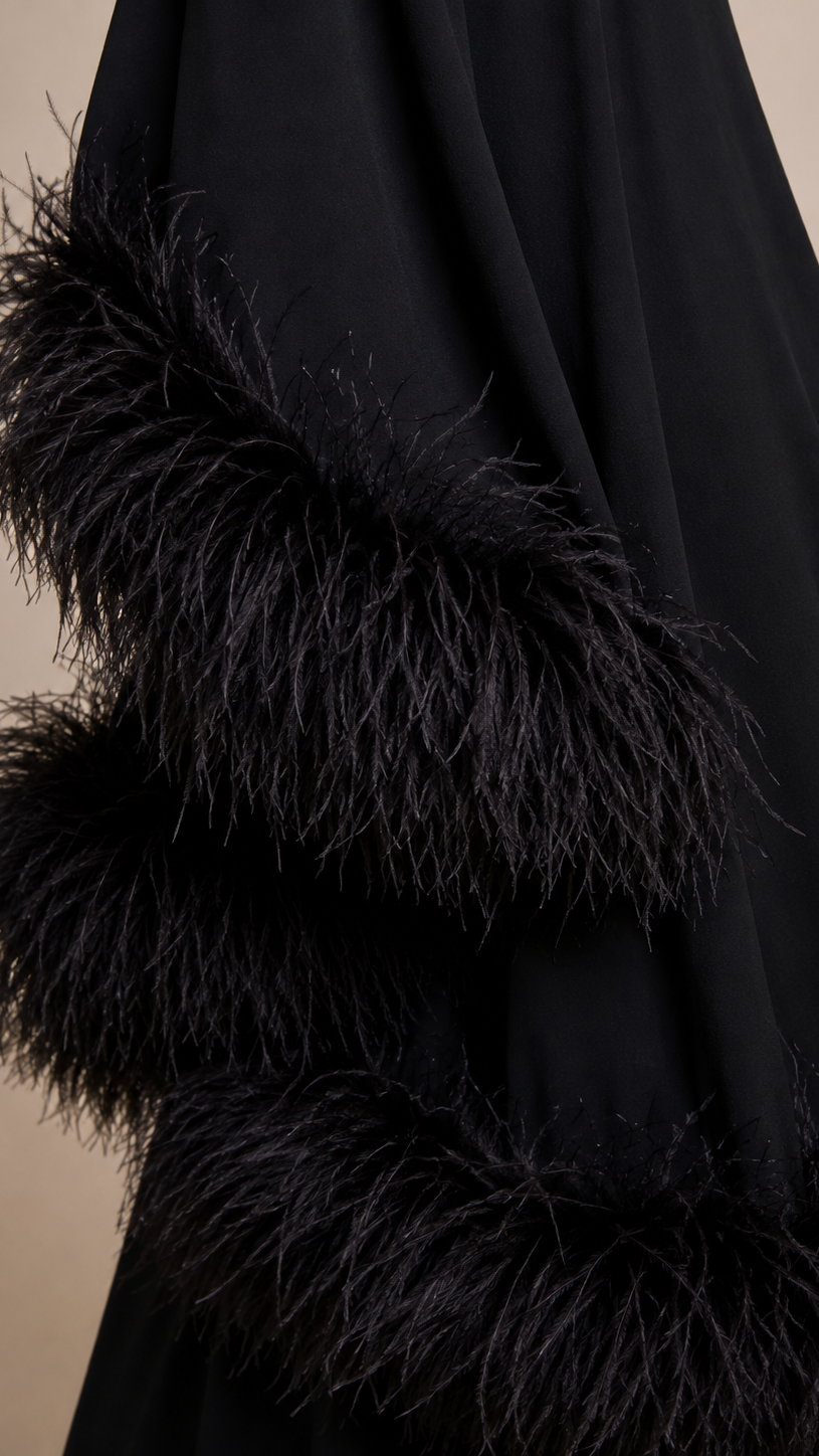 Black garment with feathered trim