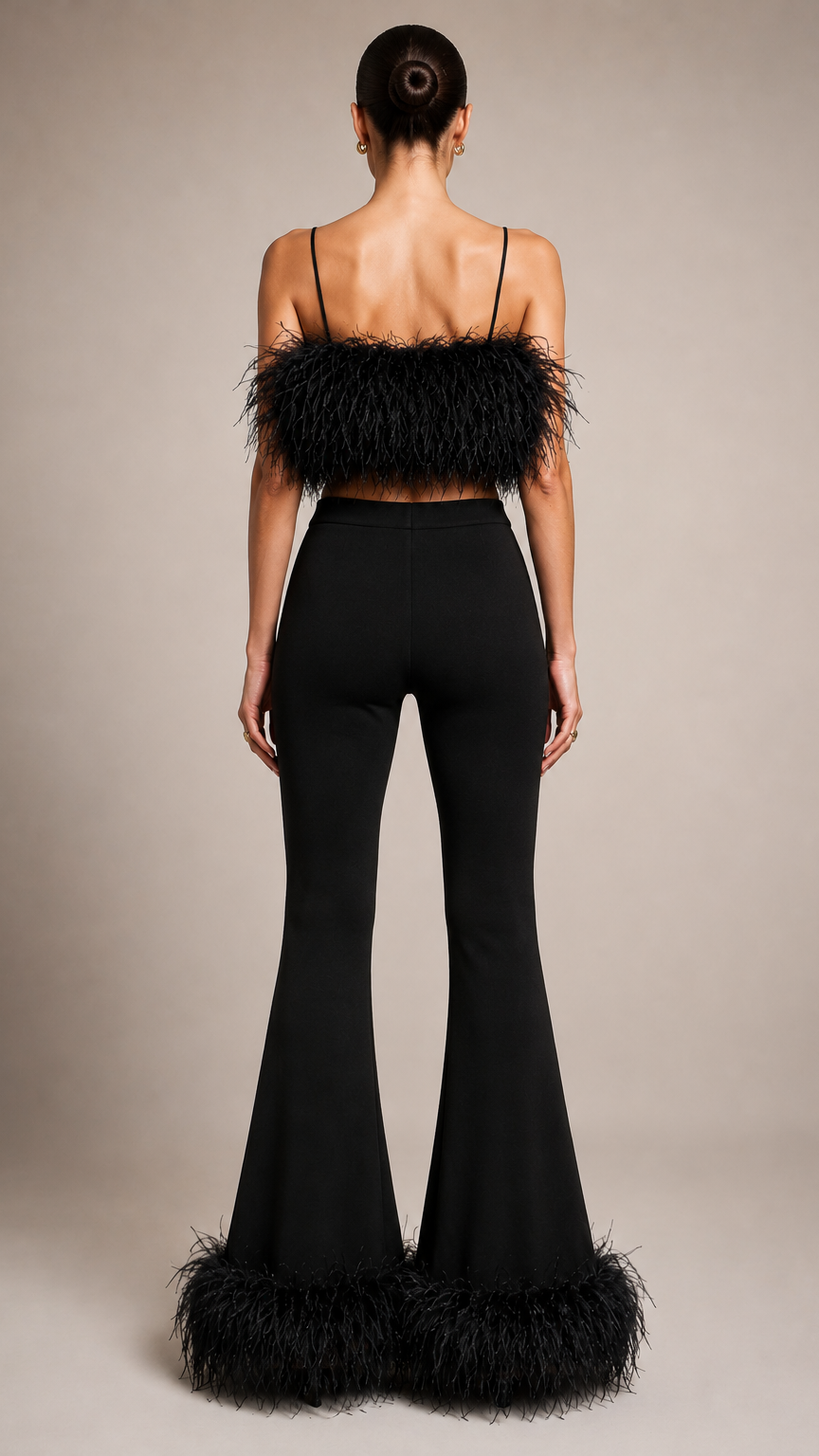 Person wearing a black outfit with feather details