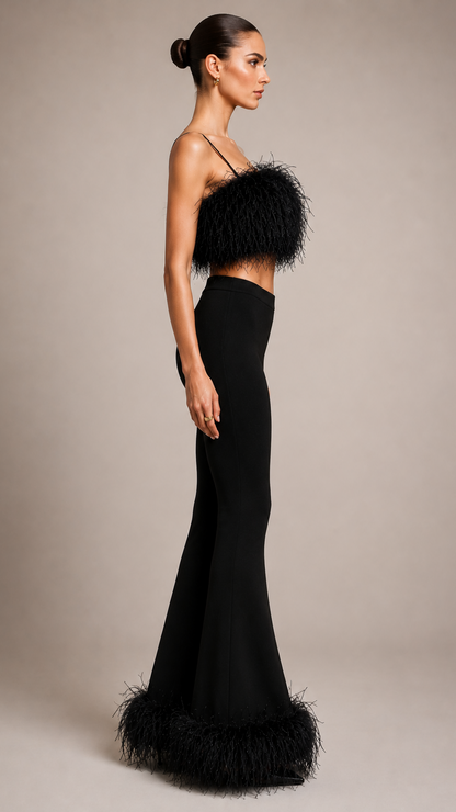 Woman wearing a black evening gown with feathered details