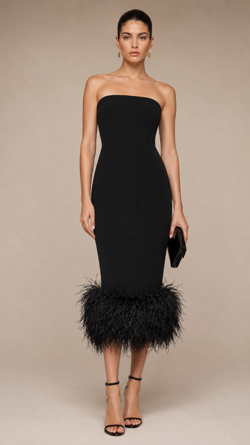 Woman wearing a black strapless dress with feather details